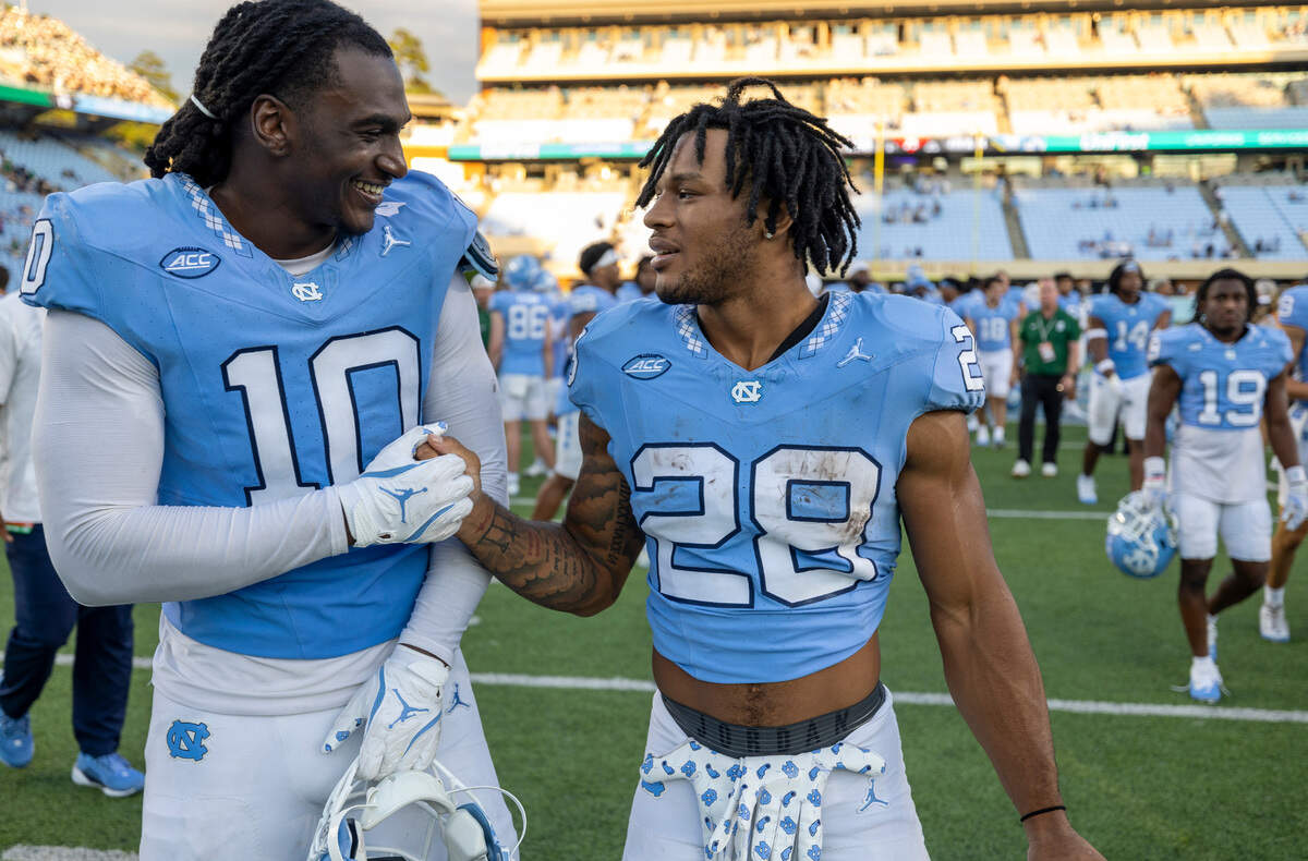 North Carolina running back Omarion Hampton (28) celebrates the Tar Heels’ 38-20 victory over Charlotte with defensive lineman Desmond Evans (10) on Saturday, September 7, 2024 at Kenan Stadium in Chapel Hill, N.C.