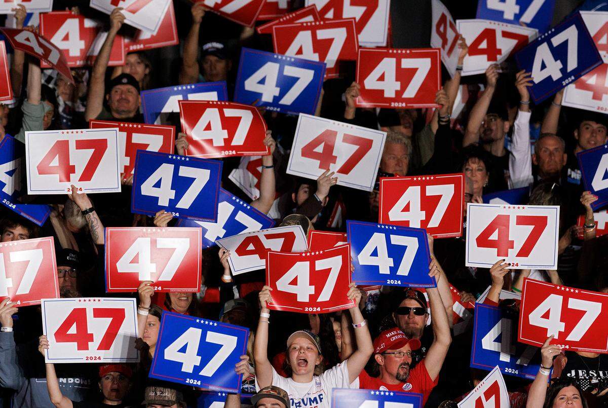 People cheer as Peter Navarro speaks during a rally in support of former President and Republican presidential candidate Donald Trump at the Greensboro Coliseum Complex on Tuesday, Oct. 22, 2024, in Greensboro, N.C.