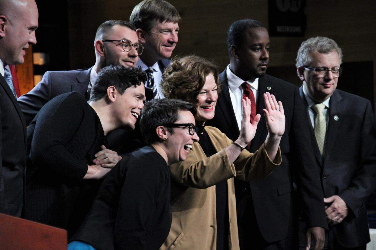 New Raleigh Mayor Mary-Ann Baldwin waves to supporters, surrounded (clockwise from bottom) City Council members Nicole Stewart, Saige Martin, Patrick Buffkin, Jonathan Melton, David Knight, Corey Branch and David Cox at Raleigh Union Station on Monday, Dec. 2, 2019.