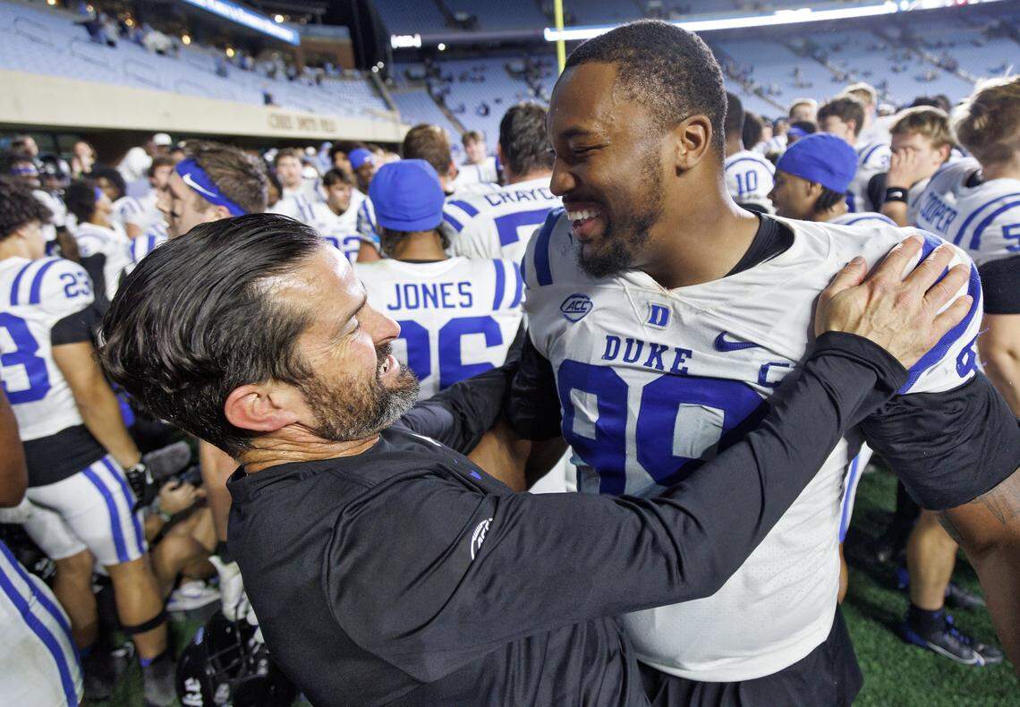 Duke head coach Manny Diaz celebrates with Aaron Hall following the Blue Devils’ 32-25 victory over North Carolina on Saturday, Nov. 22, 2025, at Kenan Stadium in Chapel Hill, N.C.