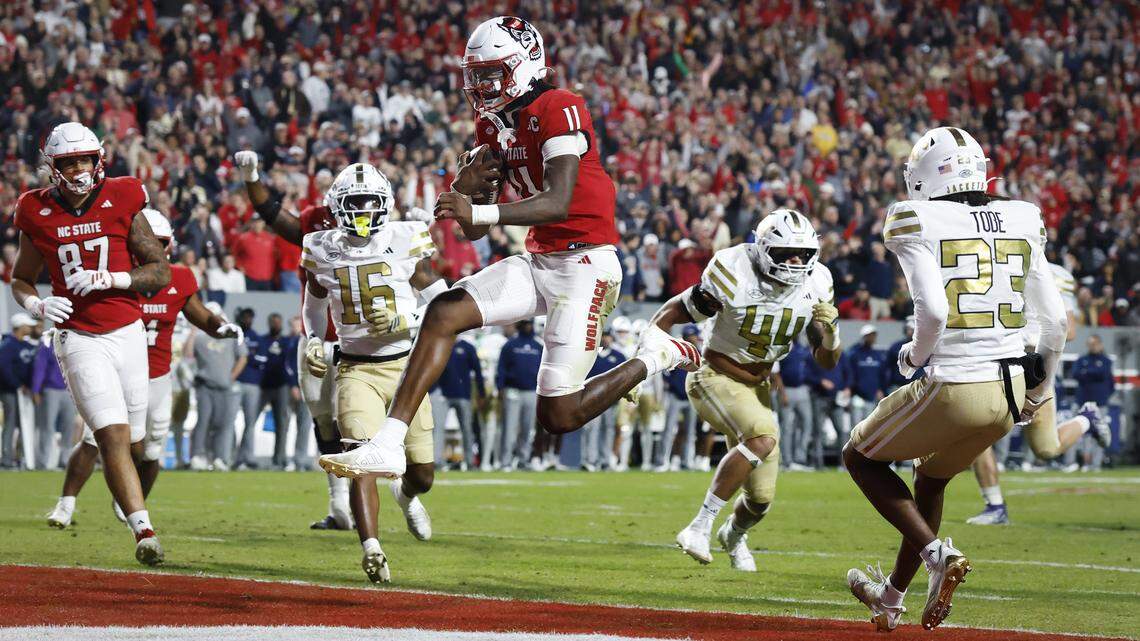 N.C. State quarterback CJ Bailey (11) scores on a 11-yard touchdown run during the first half of N.C. State’s game against Georgia Tech at Carter-Finley Stadium in Raleigh, N.C., Saturday, Nov. 1, 2025.