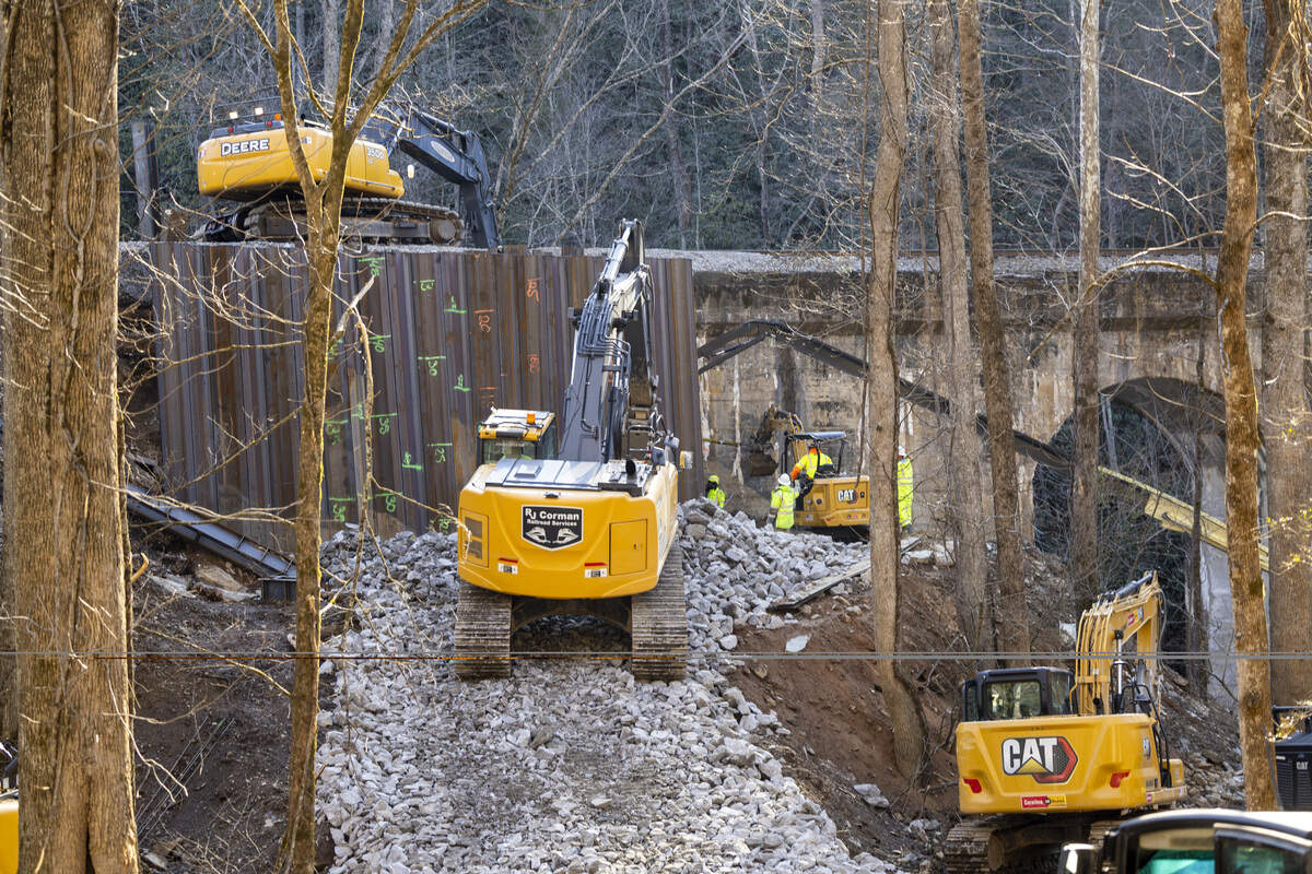 Crews work to repair a railroad bridge on a section of Norfolk Southern’s AS Line near Old Fort, east of Asheville, on Monday, Feb. 9, 2026. A 15-mile section of track, including a series of remote tunnels and horseshoe curves as it climbs and descends the Eastern Continental Divide, was severely damaged by the remnants of Hurricane Helene in 2024.