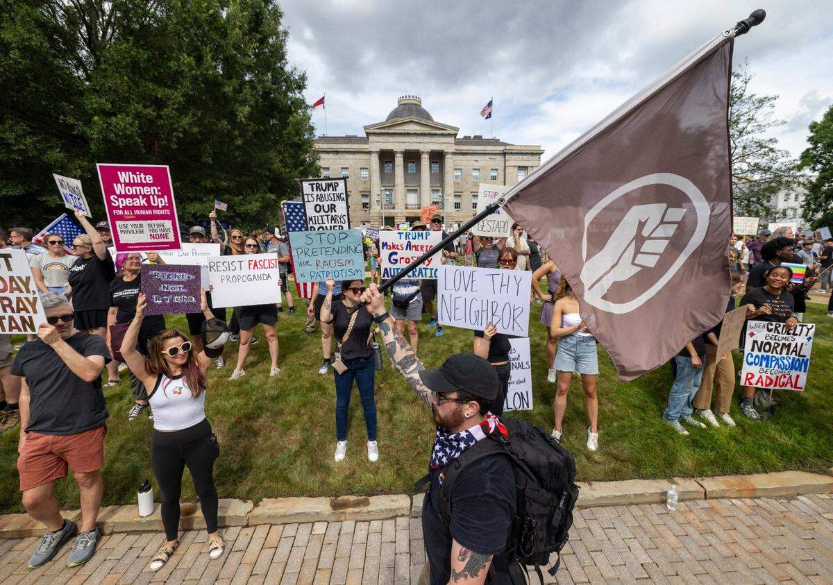 Hundreds of demonstrators line the sidewalk along S. Salisbury Street during the ‘No Kings’ rally at the North Carolina State Capital on Saturday, June 14, 2025 in Raleigh, N.C.