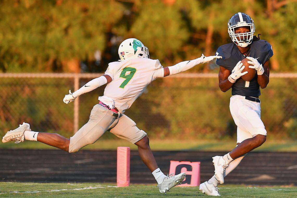Southeast Raleigh wide receiver Tyrus Whyte (7) pulls in the pass for the touchdown against Cardinal Gibbons defensive back Rylan George (9) during the first half. The Southeast Raleigh Bulldogs and the Cardinal Gibbons Crusaders met in a non-conference football game in Raleigh, N.C. September 12, 2025