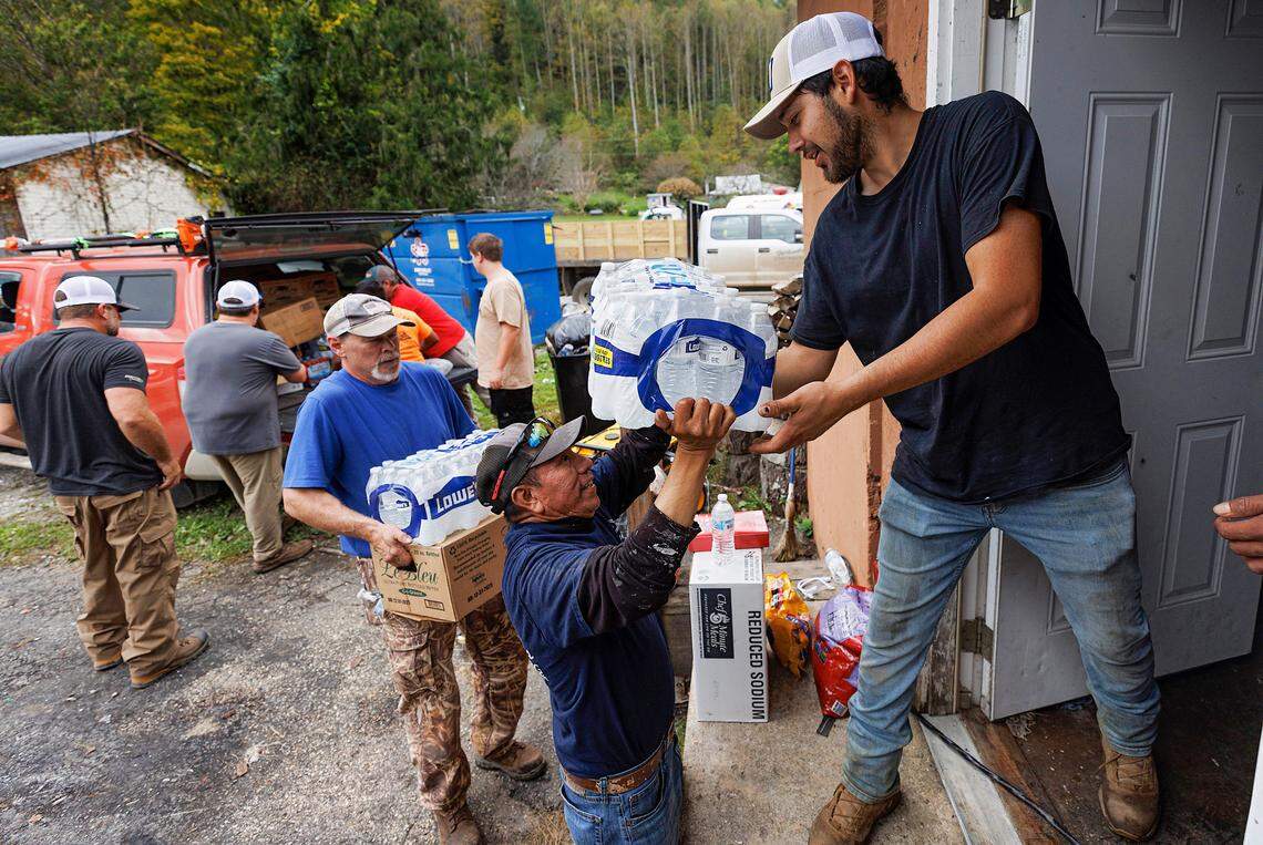 Volunteers unload donated supplies at Spear Country Store & Hardware in Avery County as residents recover from the effects of Hurricane Helene on Tuesday, Oct. 1, 2024, in Spear, N.C.