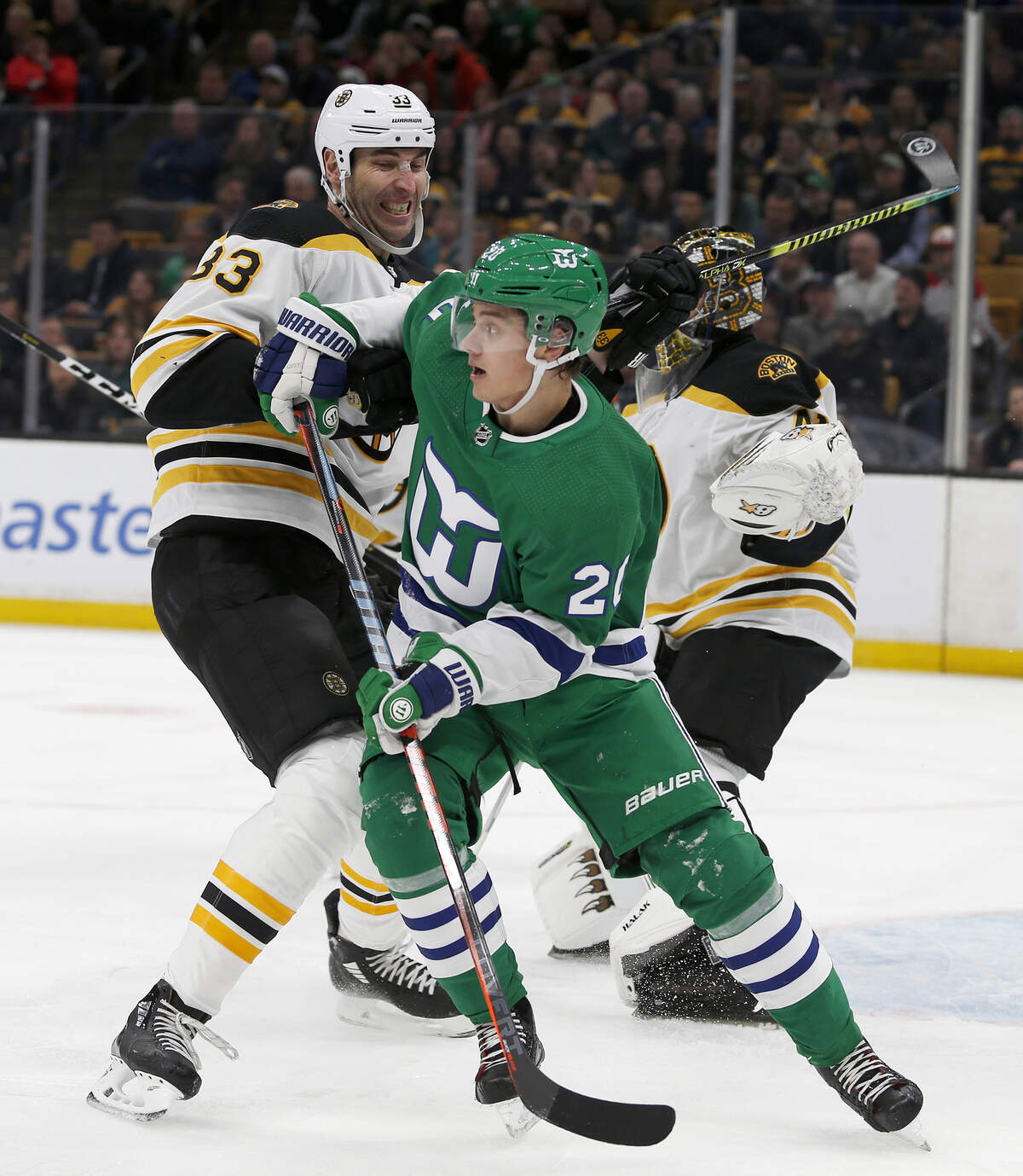 Boston Bruins defenseman Zdeno Chara (33) pushes Carolina Hurricanes center Sebastian Aho (20) away from the goal during the first period of an NHL hockey game, Tuesday, March 5, 2019, in Boston. (AP Photo/Mary Schwalm)