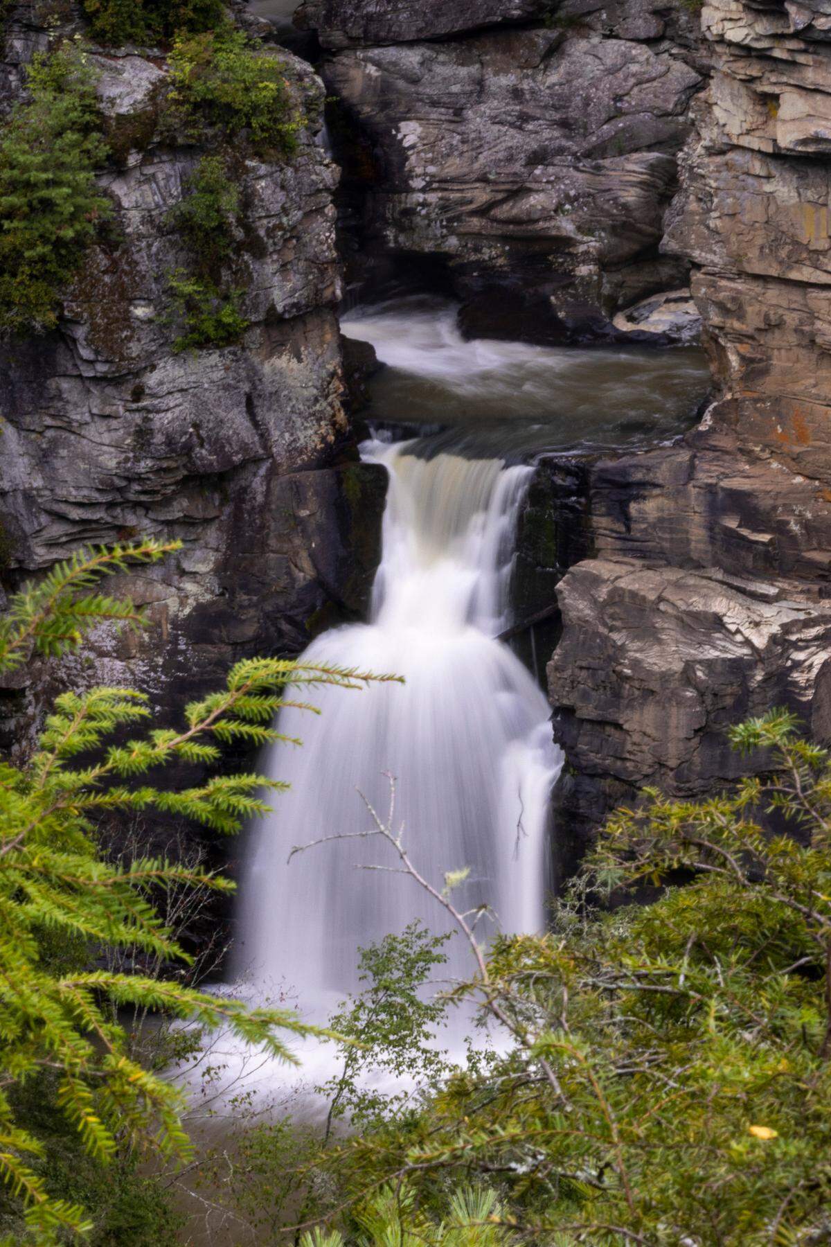 The lower falls of Linville Falls pour into the Linville Gorge as seen from the Chimney View overlook in Newland. The Chimney View Trail has reopened after crews cleared damage from Hurricane Helene.
