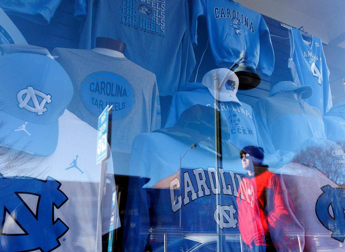 A person walks by a shop selling UNC-Chapel Hill gear on Franklin Street on Thursday, Jan. 11, 2024, in Chapel Hill, N.C.