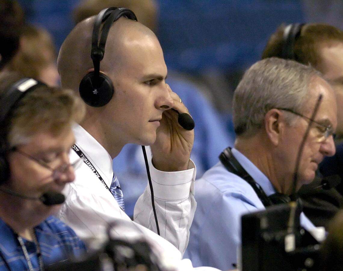 Former North Carolina center Eric Montross (center, left) prepares to broadcast with Woody Durham (center, right) prior to the start of the North Carolina-Florida State ACC tournament quarterfinal game at St. Pete Times Forum in Tampa