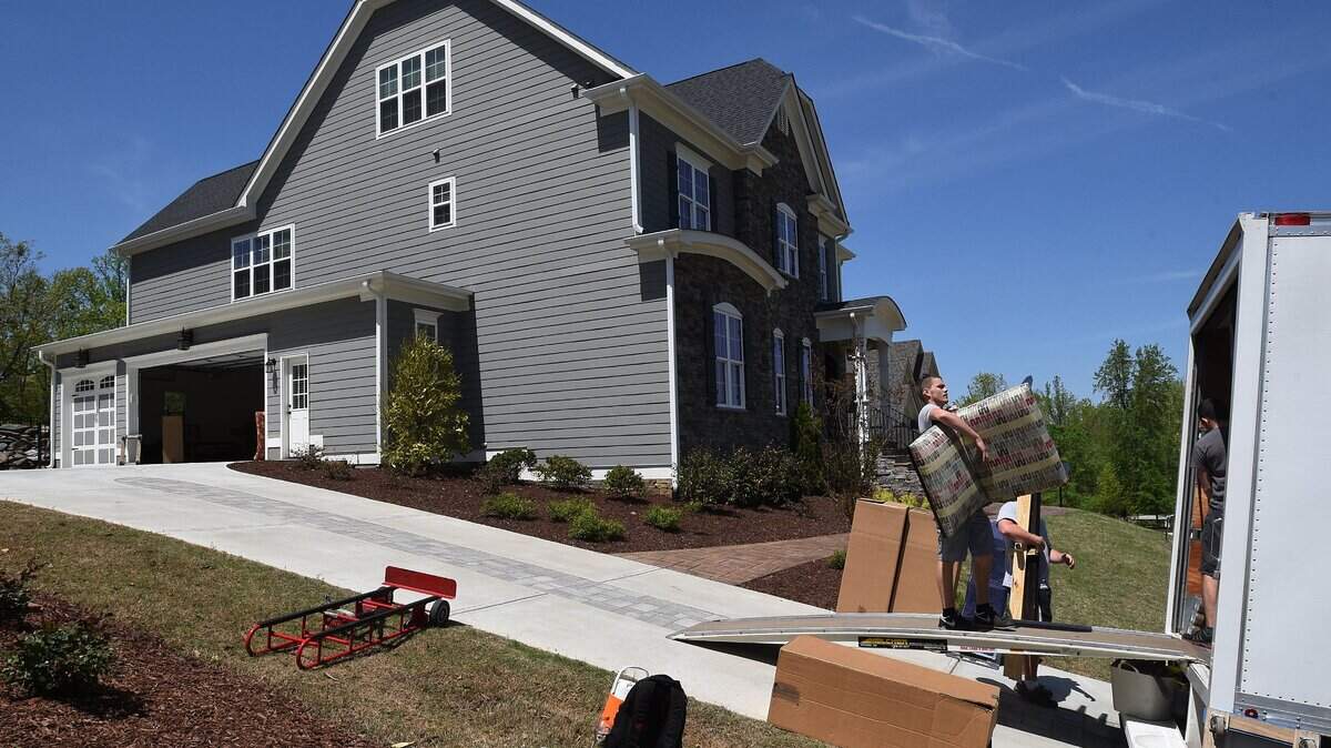 Kevin Igelko helps unload a moving van at the home of in Raleigh on April 24, 2015.