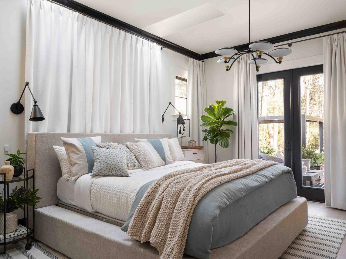 HGTV said the home’s main bedroom “is designed with natural, earthy tones with black trim, as well as an ensuite bathroom and private patio.”
