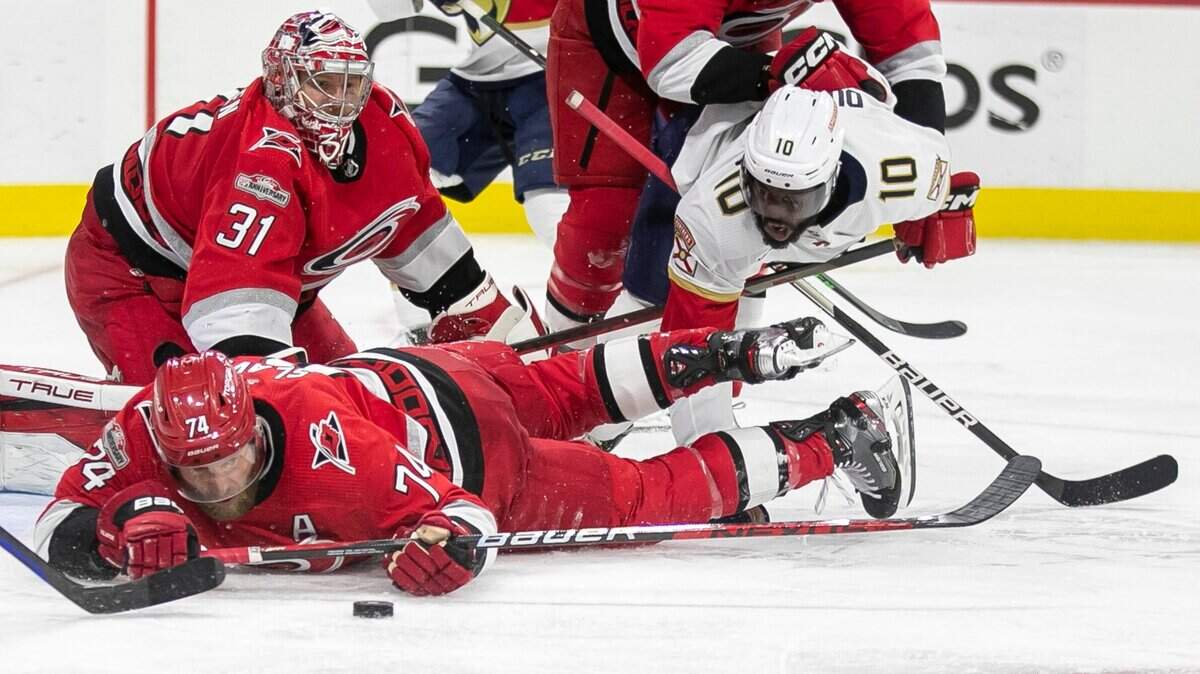The Carolina Hurricanes Jaccob Slavin (74) dives after a loose puck in front of goalie Frederik Andersen (31) against the Florida Panthers in overtime during Game 1 of the Eastern Conference Finals on Thursday, May 18, 2023 at PNC Arena in Raleigh, N. C.
