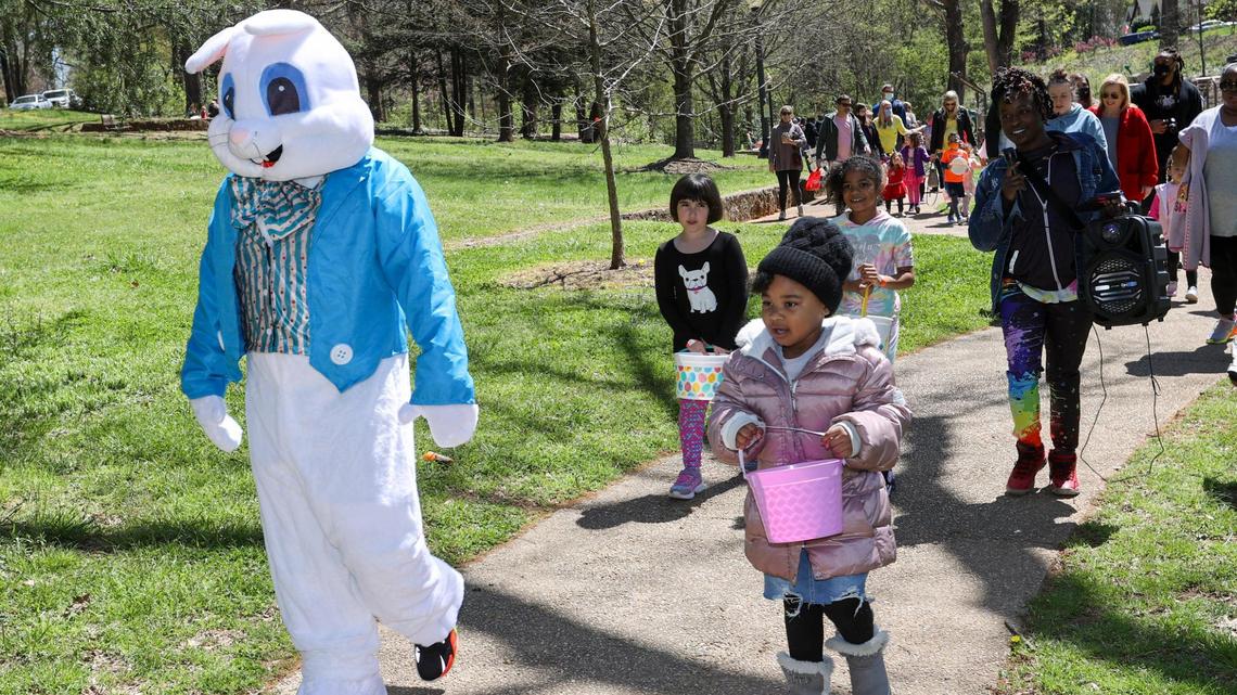 The Easter Bunny leads children to the starting line for an Easter egg hunt at the Easter Eggstravaganza at Latta Park in Charlotte, N.C., Saturday, April 3, 2021.