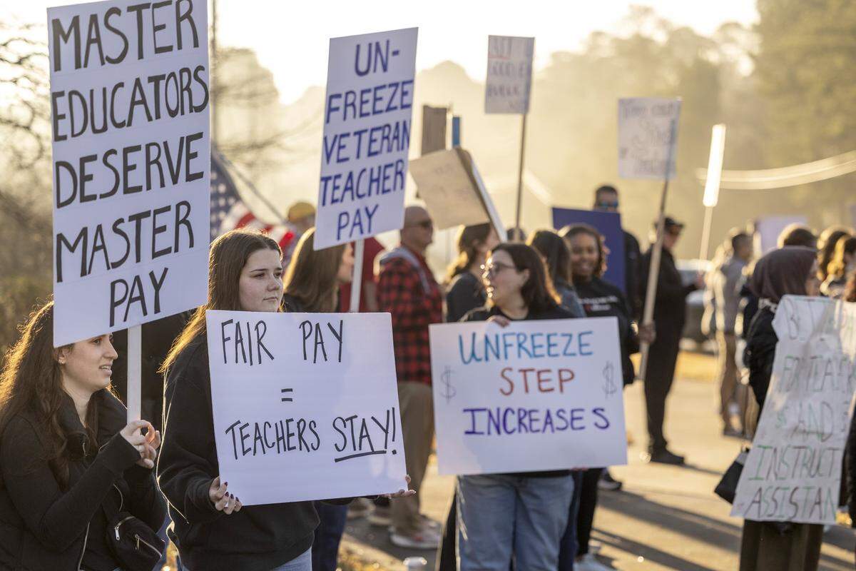 Dozens of educators demonstrate at the intersection of Green Level Church and Carpenter Fire Station roads in Cary on the morning of Jan. 7, calling on state lawmakers to provide more funding for public education. Leaders of NC Teachers in Action say 650 to 750 educators from 52 schools, including 30 in Wake County, called out of work Wednesday to participate in the protests.
