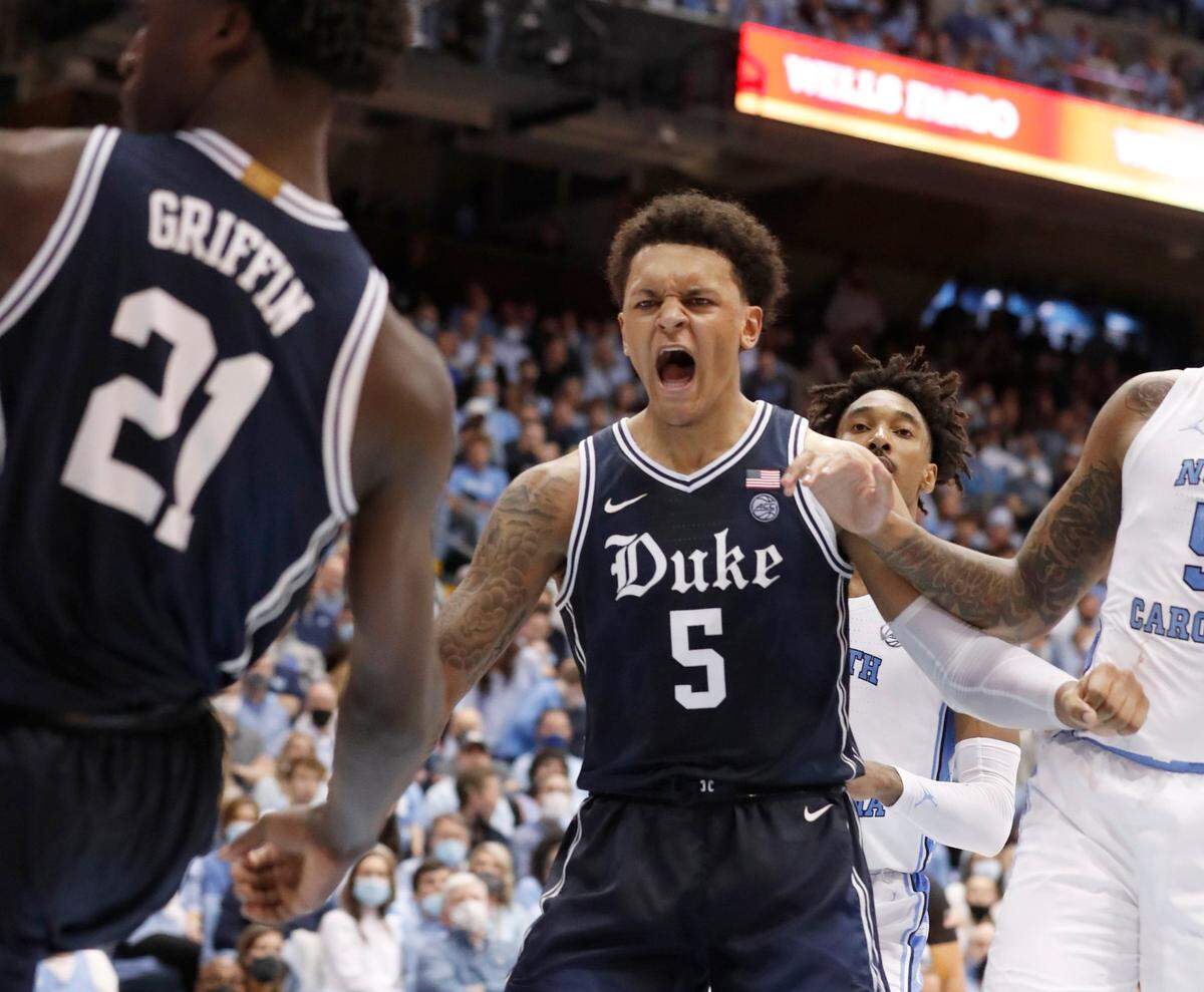 Dukes Paolo Banchero (5) celebrates the dunk by A.J. Griffin (21) during the second half of Dukes 87-67 victory over UNC at the Smith Center in Chapel Hill, N.C., Saturday, Feb. 5, 2022.