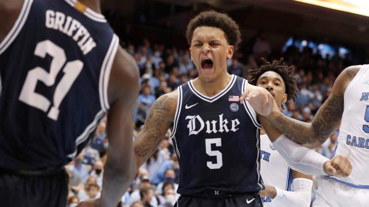 Dukes Paolo Banchero (5) celebrates a dunk by teammate AJ Griffin (21) during the second half of Duke’s 87-67 victory over UNC on Feb. 5, 2022.