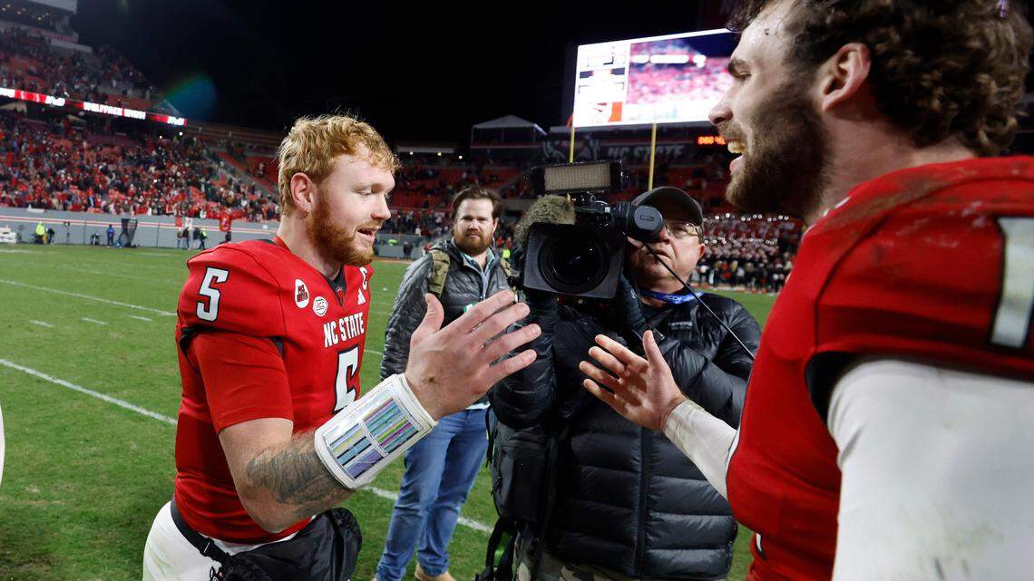 N.C. State linebacker Payton Wilson (11) celebrates with quarterback Brennan Armstrong (5) after N.C. State’s 39-20 victory over UNC at Carter-Finley Stadium in Raleigh, N.C., Saturday, Nov. 25, 2023.