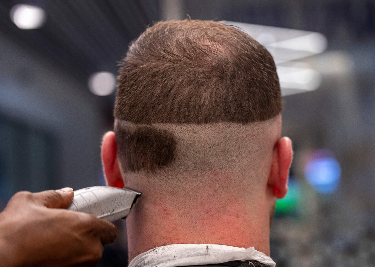 Barber Lionel Poteat shaves the back of North Carolina offensive lineman Zach Greenberg’s head at the team’s barber shop on Tuesday, September 10, 2024 at Kenan Stadium in Chapel Hill, N.C.