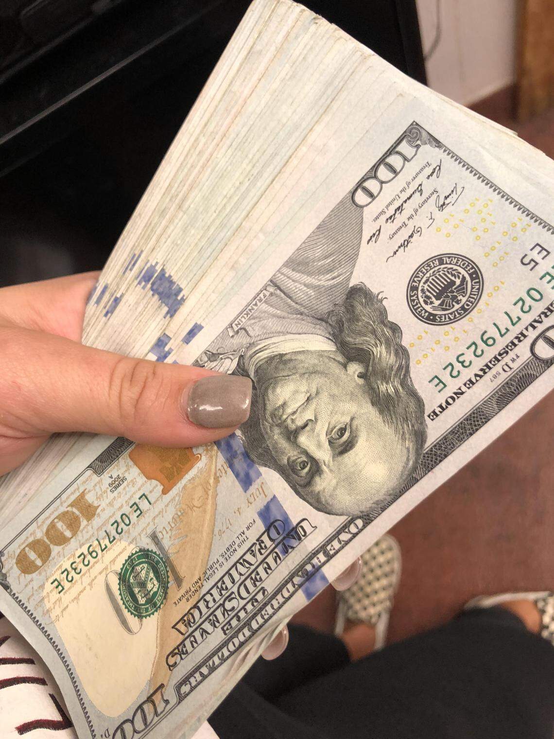 Sup Dogs server and ECU student Alaina shows off the $10,000 cash tip YouTuber Mr. Beast left her on Saturday, Oct. 20, 2018.