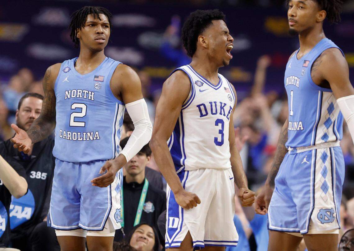 Dukeís Jeremy Roach (3) celebrates after making the basket while being fouled during the first half of Dukeís game against UNC in the Final Four at Caesars Superdome in New Orleans, La., Saturday, April 2, 2022. North Carolina’s Caleb Love (2) and North Carolina’s Leaky Black (1) stand around him.