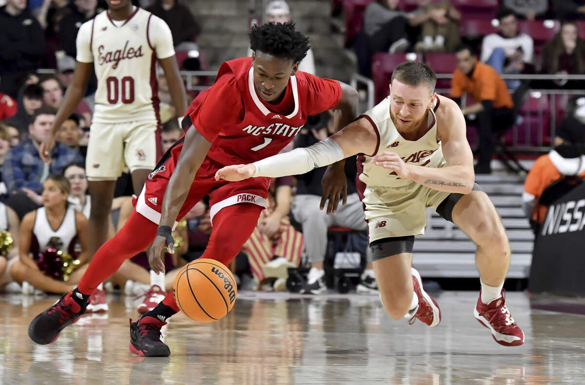 North Carolina’s Jarkel Joiner (1) and Boston College’s Mason Madsen (45) chase a loose ball during the second half of an NCAA college basketball game, Saturday, Feb. 11, 2023, in Boston. (AP Photo/Mark Stockwell)