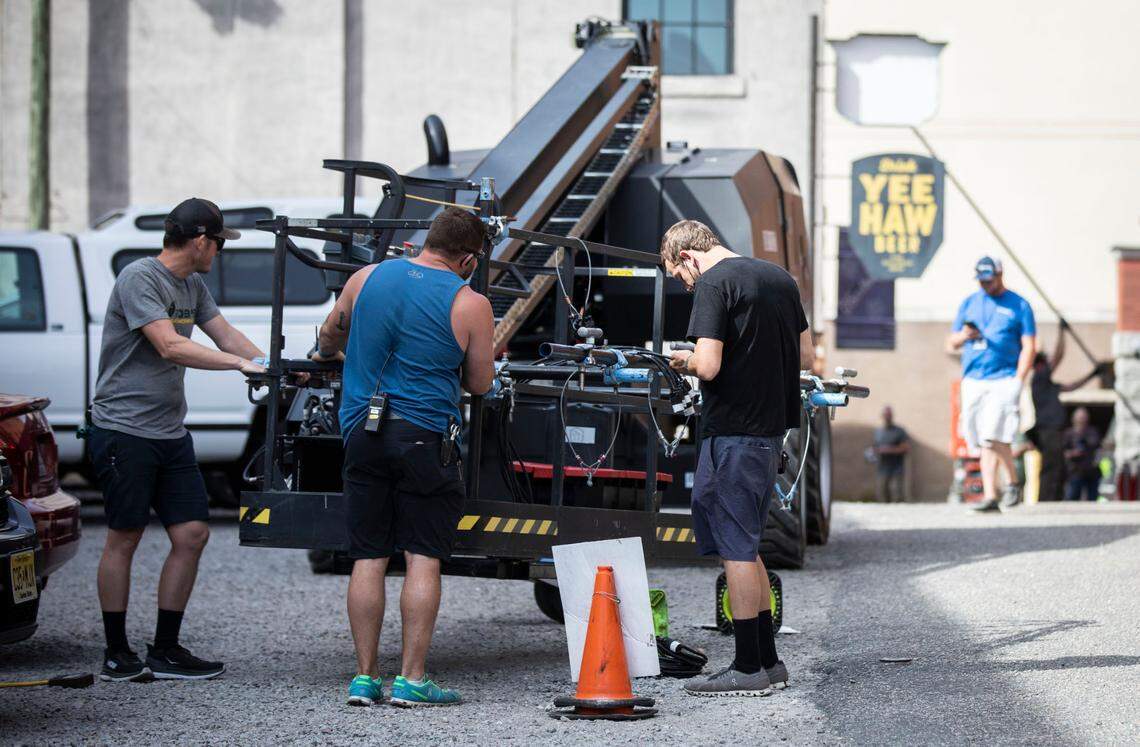 Members of a production crew set up to film a scene in downtown Wilmington, N.C. for the drama mini-series “George and Tammy” on Friday, March 18, 2022.