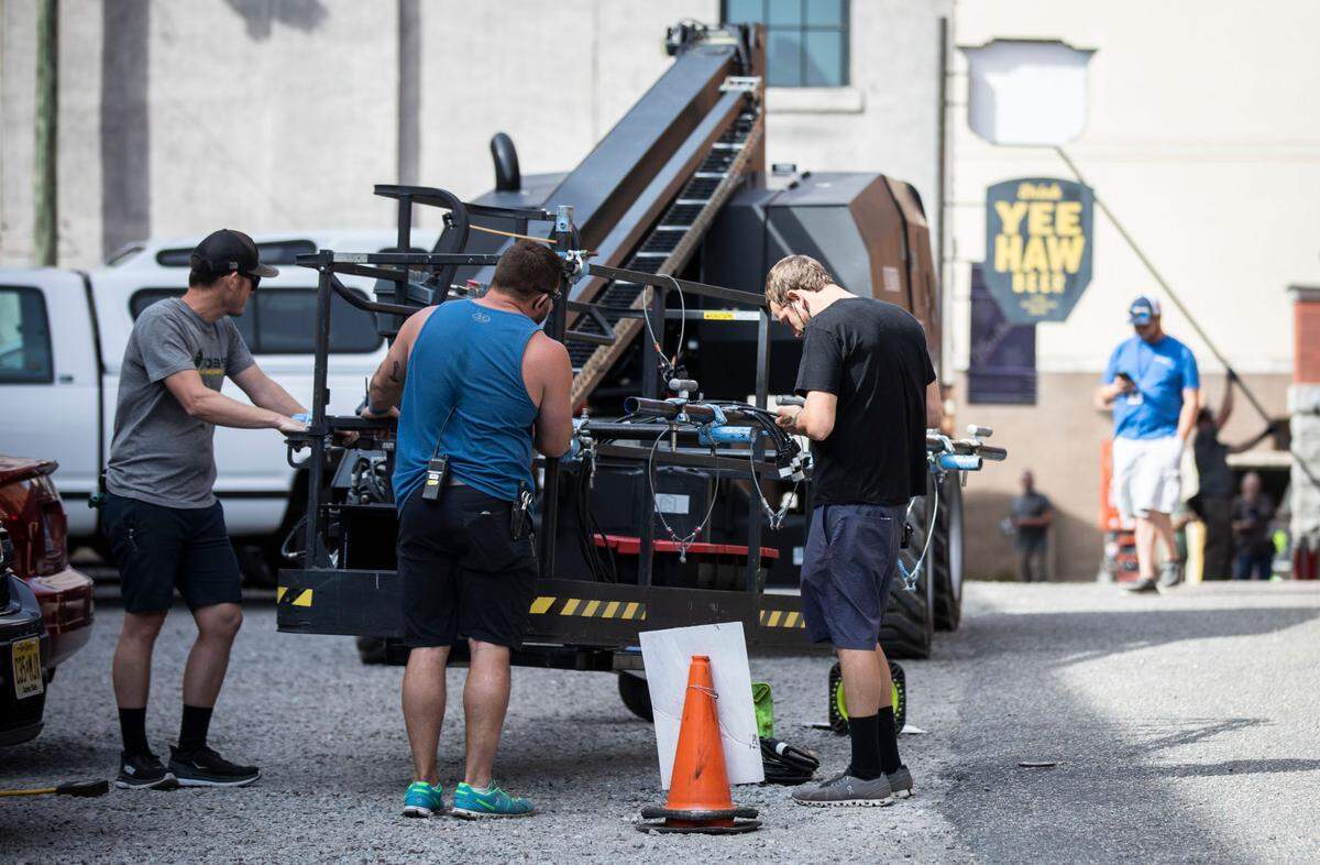 Members of a production crew set up to film a scene in downtown Wilmington, N.C. for the drama mini-series “George and Tammy” on Friday, March 18, 2022.