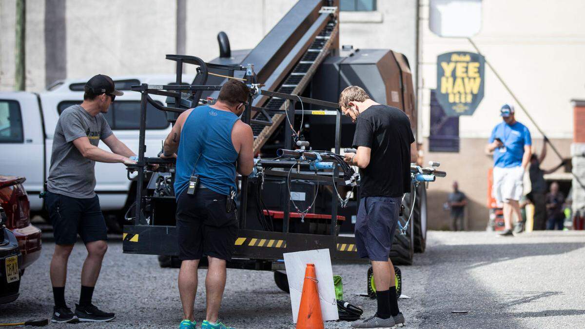 Members of a production crew set up to film a scene in downtown Wilmington, N.C. for the drama mini-series “George and Tammy” on Friday, March 18, 2022.