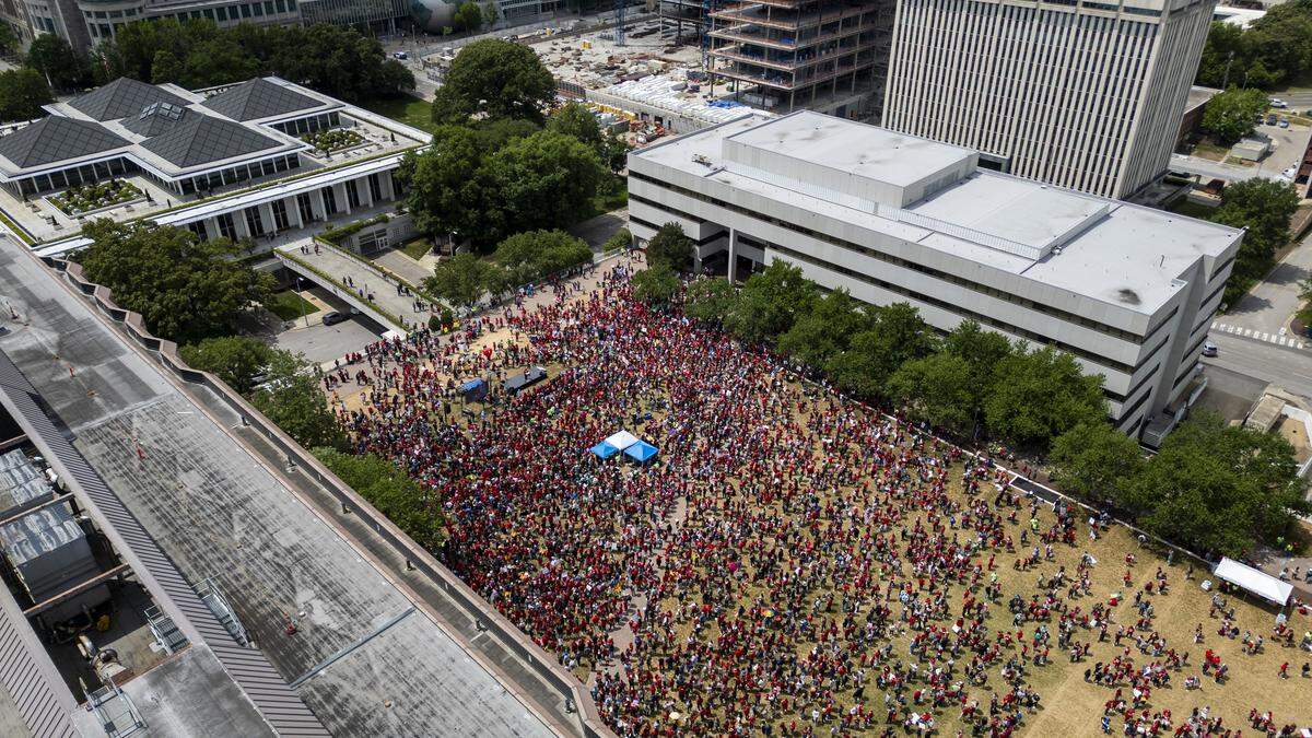 Thousands of educators and public education supporters demonstrate on Halifax Mall in Raleigh on Friday, May 1, 2026, calling for higher pay, increased school funding and higher taxes on corporations during a “Kids Over Corporations” rally and march at the North Carolina General Assembly organized by the North Carolina Association of Educators. At least 22 school districts canceled classes because many employees requested the day off.