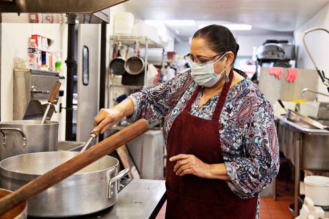 Ravinder Kaur, who owns Plaza Cafe in downtown Raleigh with her son, prepares lunch on Tuesday, Jan. 11, 2022. Kaur was preparing some dishes with items she bought for New Years thinking they would have more business.