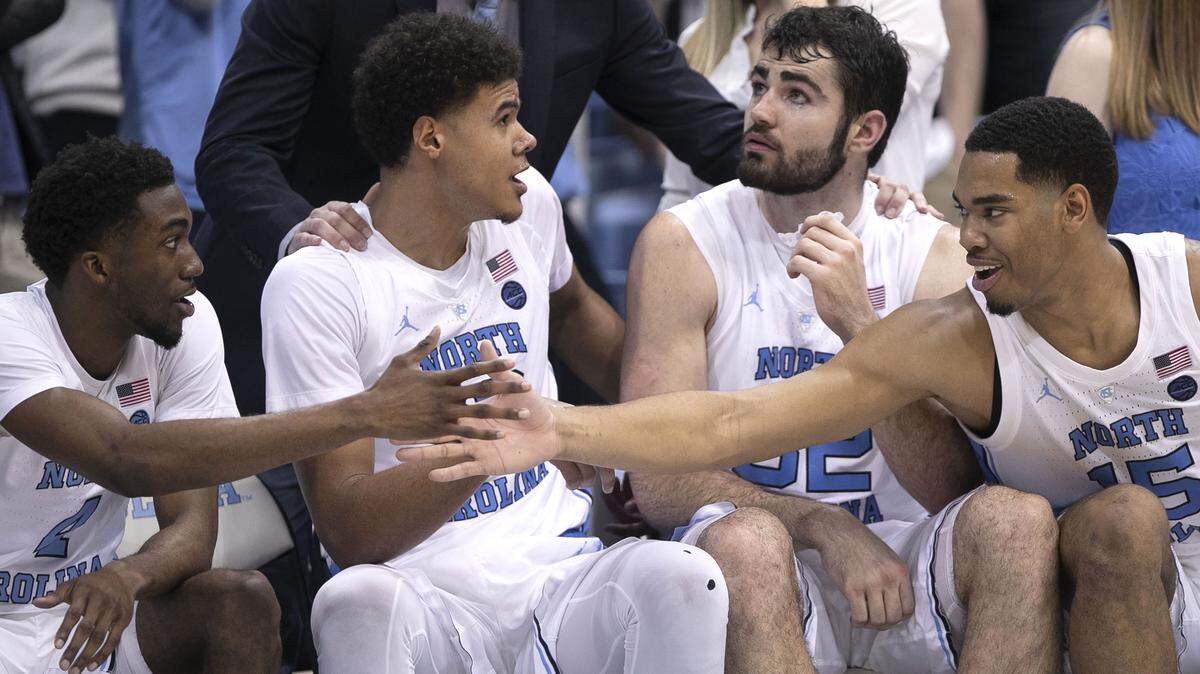 North Carolina’s Brandon Robinson (4), Cameron Johnson (13), Luke Maye (32) and Garrison Brooks (15) congratulate each other after coming out of the game in the final minute against Gonzaga on Saturday, December 15, 2018 at the Smith Center in Chapel Hill, N.C.