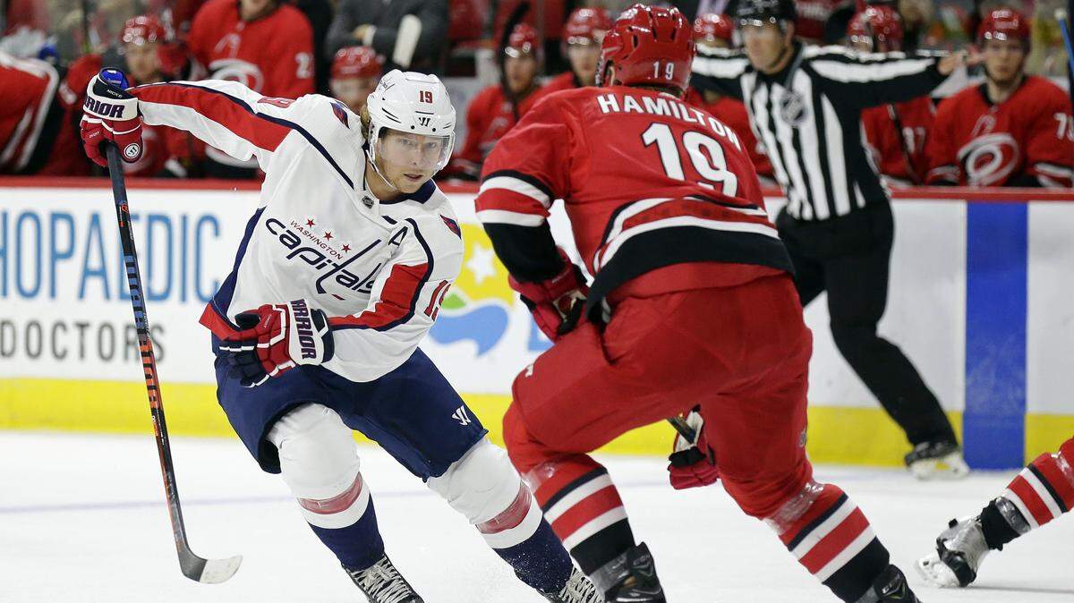 Washington Capitals’ Nicklas Backstrom (19), of Sweden, skates against Carolina Hurricanes’ Dougie Hamilton during the first period of a preseason NHL hockey game in Raleigh, N.C., Friday, Sept. 21, 2018. (AP Photo/Gerry Broome)