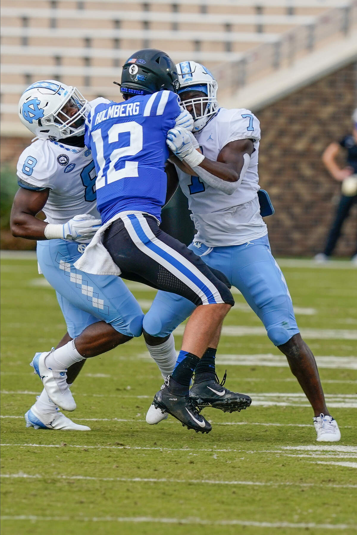 North Carolina Tar Heels linebacker Khadry Jackson (8) and linebacker Eugene Asante (7) hit Duke Blue Devils quarterback Gunnar Holmberg (12) during the second half at Wallace Wade Stadium. 