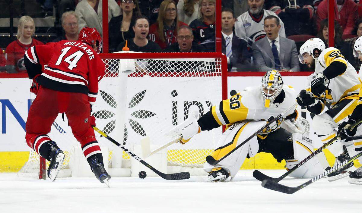 Carolina Hurricanes’ Justin Williams (14) shoots the puck past Pittsburgh Penguins goaltender Matt Murray (30) to tie the game late in the third period of an NHL hockey game, Tuesday, March 19, 2019, in Raleigh, N.C. Hurricanes won 3-2 by shoot out. (AP Photo/Karl B DeBlaker)