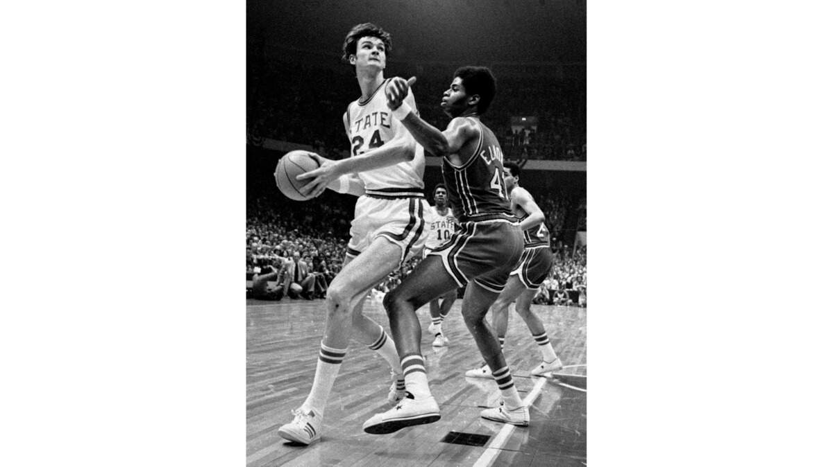 NC State center Tommy Burleson drives against Maryland center Len Elmore in the 1974 ACC Tournament championship game.