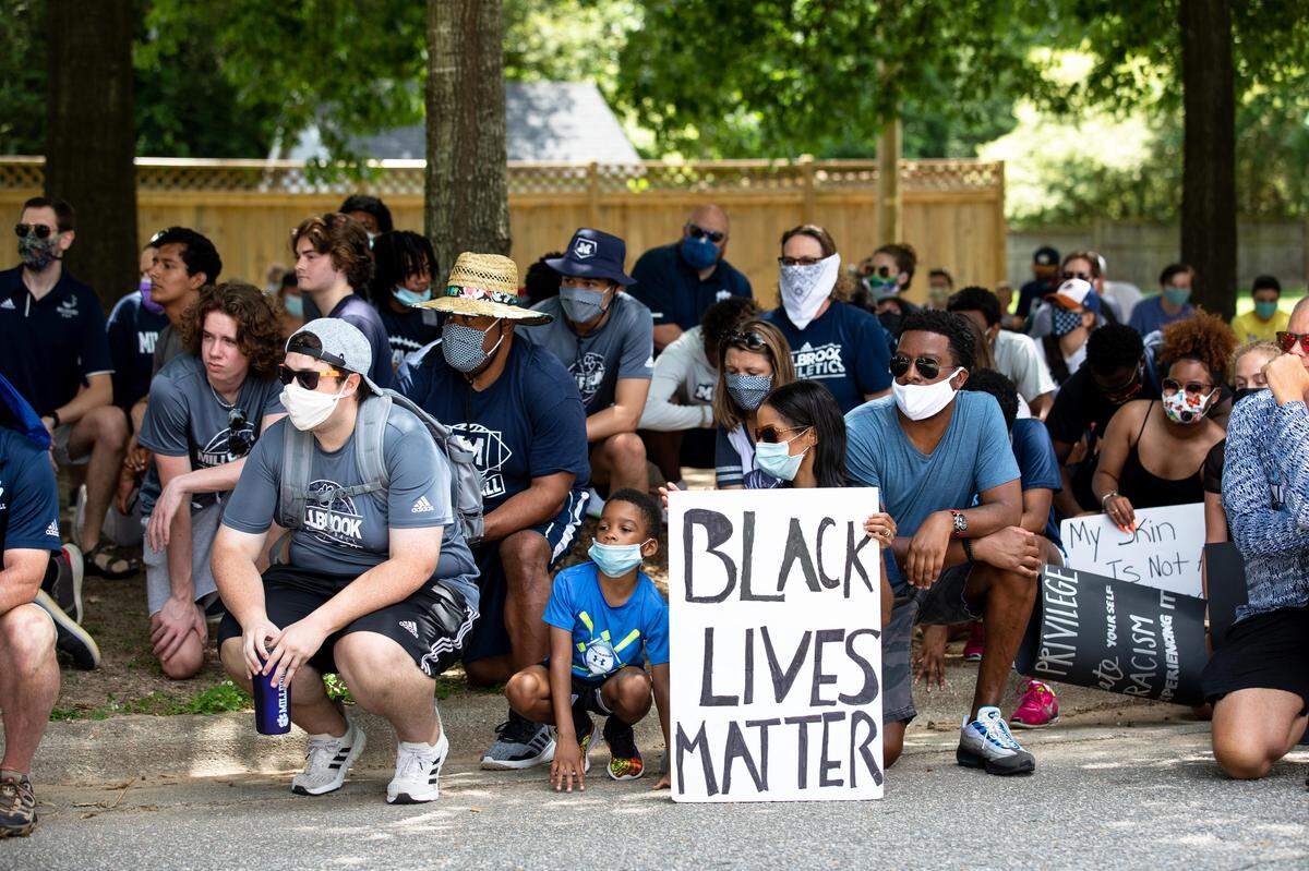 A group of eductaors kneel in honor of George Floyd, who was killed by a Minneapolis police officer in Raleigh, N.C. on Saturday, June 6, 2020.. The teachers gathered to show support for students of color amid nationwide protests inspired by George Floyd’s death.