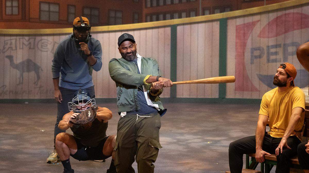 Nik Walker, playing the role of Crash, swings a bat during a rehearsal of “Bull Durham” the musical on Thursday, Sept. 12, 2024, at Reynolds Industries Theater on Duke University campus.