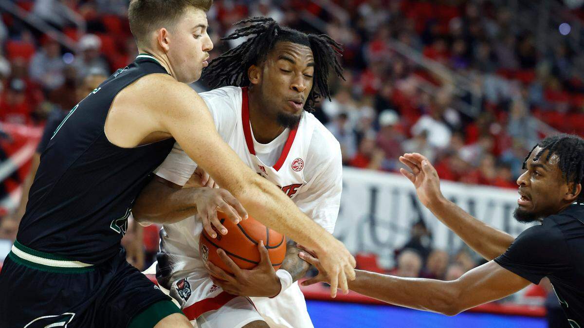N.C. State’s Jayden Taylor (1) drives by Mount Olive’s Colin Radcliffe (25) during the first half of N.C. State’s exhibition game against Mount Olive at PNC Arena in Raleigh, N.C., Wednesday, Nov. 1, 2023.