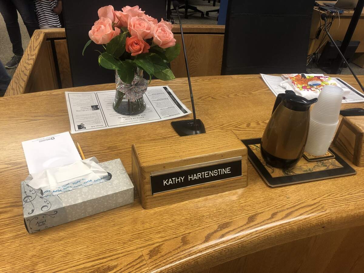 Flowers were placed at the empty seat of Wake County school board member Kathy Hartenstine at the Oct. 2, 2018 school board meeting in Cary, N.C. Hartenstine unexpectedly passed away on Sept. 23, 2018.