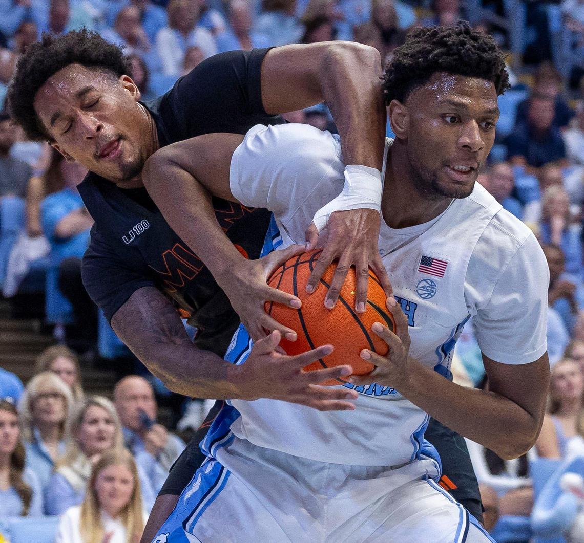 North Carolina forward Jalen Washington (13) battles with Miami forward Brandon Johnson (2) for rebound in the first half on Saturday, March 1, 2025 at the Smith Center in Chapel Hill, N.C.