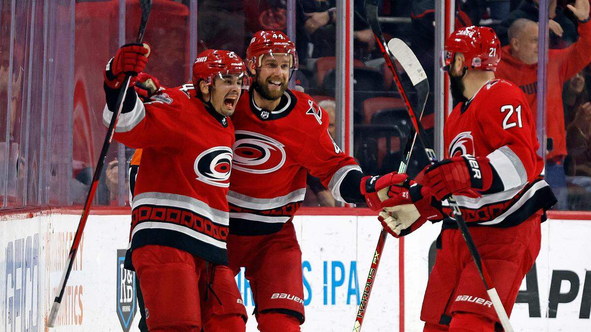 Carolina Hurricanes’ Seth Jarvis, left, celebrates his hat trick goal with teammates Calvin de Haan, center, and Derek Stepan (21) during the third period of an NHL hockey game against the Montreal Canadiens in Raleigh, N.C., Thursday, Feb. 16, 2023. (AP Photo/Karl B DeBlaker)