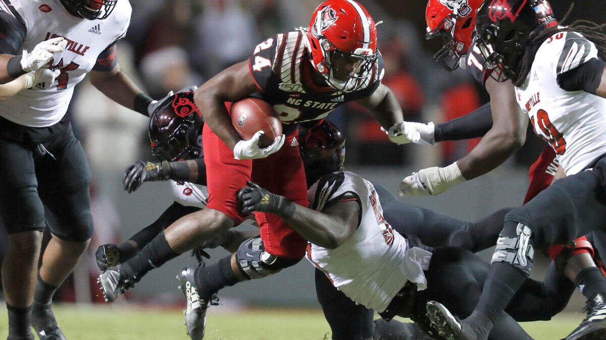 N.C. State running back Bam Knight (24) breaks free from Louisville defensive lineman Amonte Caban (53) during the Wolfpack’s game against Louisville at Carter-Finley Stadium in Raleigh, N.C., Saturday, Nov. 16, 2019.