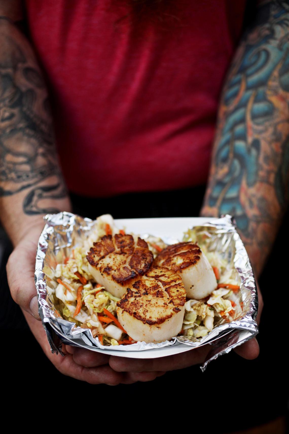 Hale Yeah Kitchen’s pan-seared scallops are served three to an order over Asian slaw.