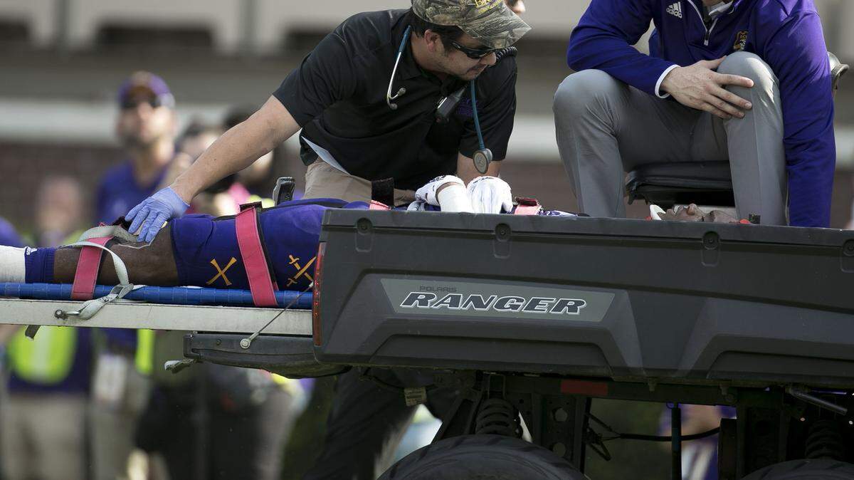 Medical personnel help East Carolina’s Colby Gore as he is transported from the field after a illegal helmet-to-helmet contact from UNC running back Antonio Williams on Sept. 8.