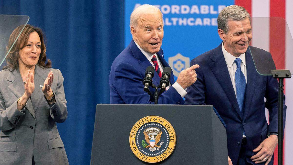 Vice President Kamala Harris, President Joe Biden and Gov. Roy Cooper join each other on stage after speeches on heath care during a campaign stop at the Chavis Community Center in Raleigh on Tuesday, March 26, 2024.