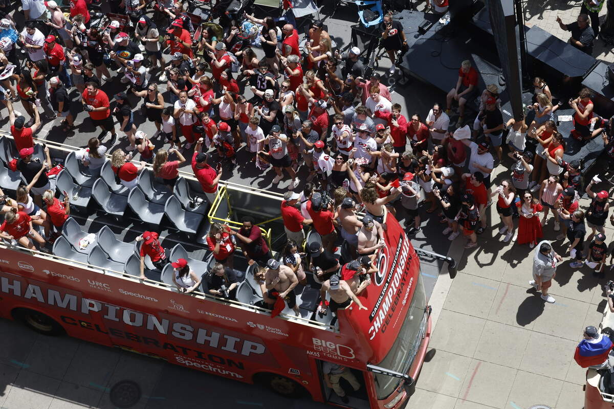 Buses carrying Carolina Hurricanes players and families along the parade route celebrating their Stanley Cup Championship.