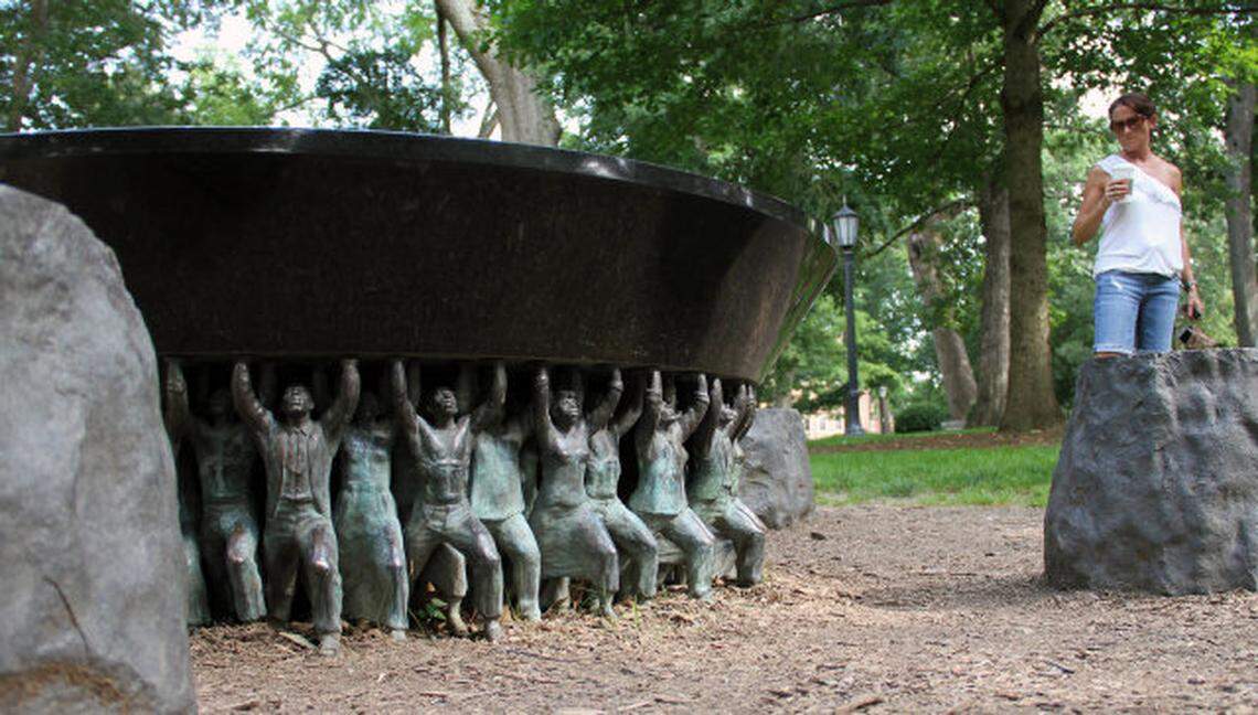 The Unsung Founders Memorial on on the UNC campus honors the men and women of color – enslaved and free – who helped build UNC-Chapel Hill, Carolina, according to the university. The memorial was installed on May 11, 2005. Three hundred figurines based on three larger bronze sculptures support the memorial, which contains the inscription: “The Class of 2002 honors the University’s unsung founders – the people of color bond and free – who helped build the Carolina that we cherish today.”