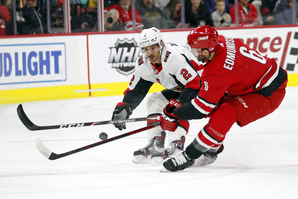 Ottawa Senators’ Dylan DeMelo (2) battles with Carolina Hurricanes’ Joel Edmundson (6) during the first period of an NHL hockey game in Raleigh, N.C., Monday, Nov. 11, 2019. (AP Photo/Karl B DeBlaker)
