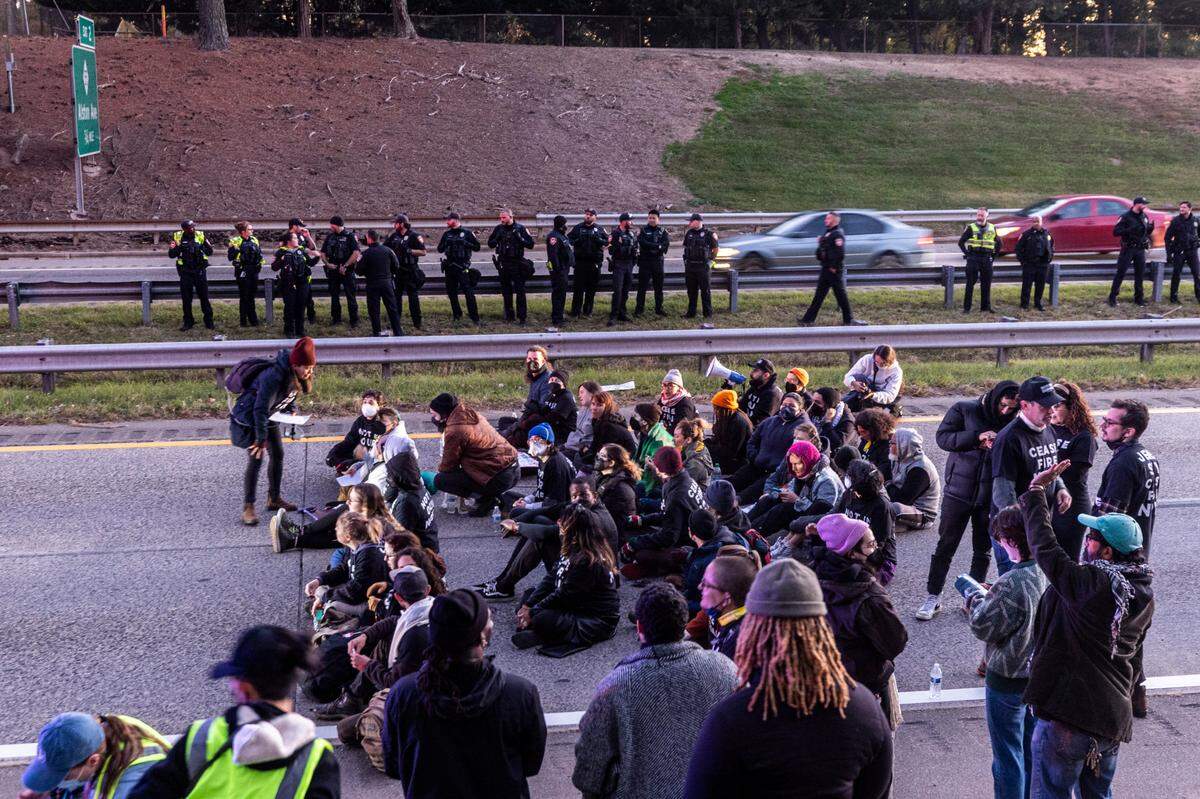 Protesters block the northbound lanes of the Durham Freeway at the South Magnum Street bridge for hours Thursday evening, Nov. 2, 2023 while demanding a ceasefire in the Israel-Gaza War as police warned of arrests.