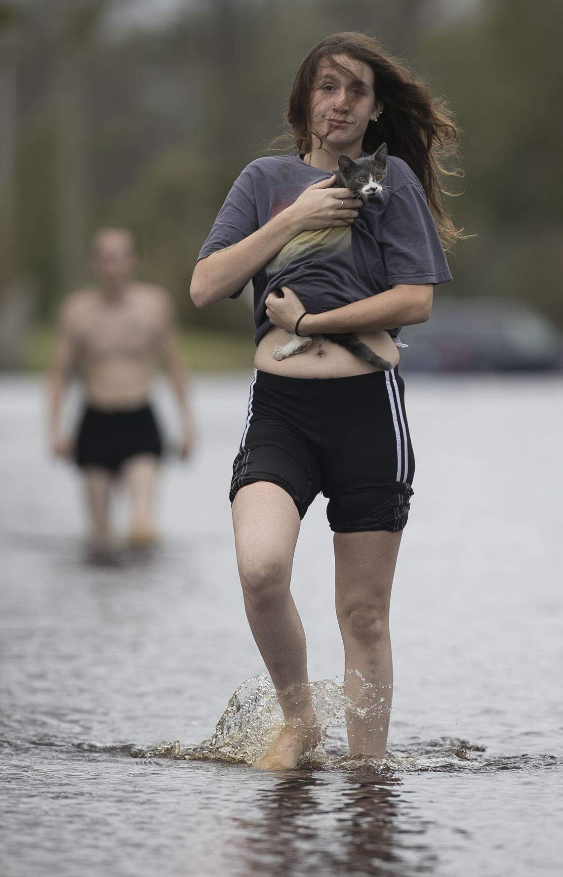 Amanda Mason on Newport, N.C. carries a cat she rescued from her neighborhood off of Nine Foot Road on Sunday afternoon September 16, 2018. Mason and her partner Zack McWilliams visited their damaged home and found the displaced cat and carried it out to safety. Their home was flooded by fast rising water from a tributary of the Newport River on Friday night.